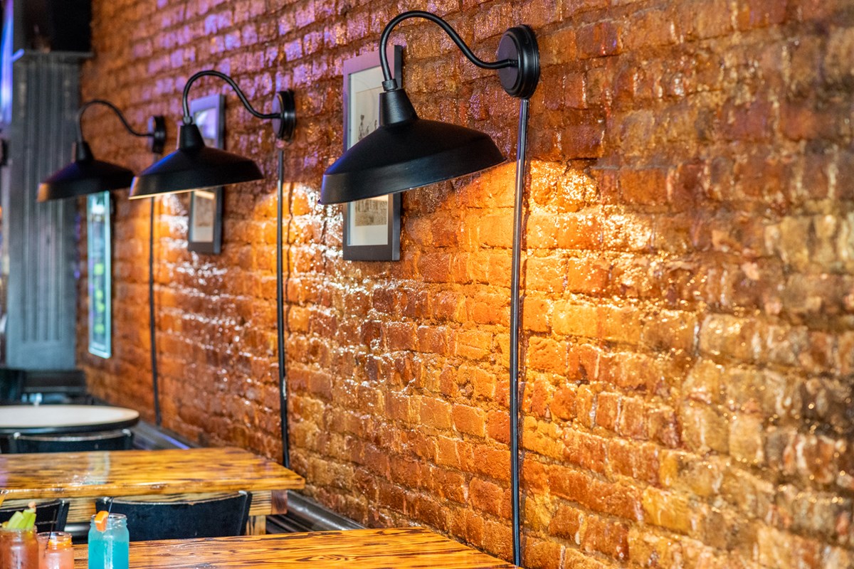 Spotlights along the brick wall at 1877 Pub & Grub